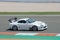 Closeup shot of a white fourth-generation Toyota Supra Japanese sports car racing on the race track
