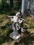 Closeup shot of a white garden statue of a girl holding flower pots