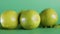 Closeup shot of whole fresh lime fruit on isolated green surface