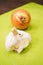 Closeup shot of a whole and unpeeled white onion and half of a garlic head on a chopping board