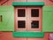 Closeup shot of a window of pink and green dollhouse