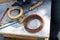 Closeup shot of wires, scissors, tape, cutter, and other tools on a white wooden table