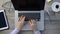 Closeup shot of a woman hand typing on keypad of her laptop. Girl is working in office at computer. Focus on typing on keypad of