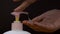 Closeup shot of a woman hands using a liquid soap dispenser - hygiene concept