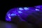 Closeup shot of a woman in a nail salon. Close up of a uv led lamp with a female hand inside fixing the gel nail polish . Woman