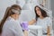 Closeup shot of woman in nail salon receiving manicure by beautician with nail file and machine. Woman getting nail