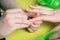 Closeup shot of a woman in a nail salon receiving a manicure by a beautician with nail file. Woman getting nail manicure