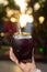 Closeup shot of the woman's hand holding a black mate cup with mate bombilla.