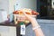 Closeup shot of woman\'s hands holding a bratwurst in bread drizzled with ketchup and mustard