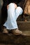 Closeup shot of a women wearing winter rubber sole leather boots and sitting on the stairs