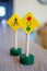 Closeup shot of a wooden traffic light toy with a pedestrian sign behind it