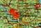 Closeup shot of a world map with a red pushpin pointing the city of Hamburg in Germany