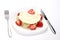 Closeup shot of wrapped pancake decorated with strawberries and cream on a white plate