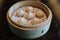 Closeup shot of Xiao Long Bao steamed soup dumplings in a bamboo steamer basket