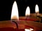 Closeup shot of yellow burning flickering candles