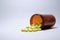 Closeup shot of yellow tablets fallen out brown bottle on white background