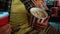 Closeup shot of young guy holding popcorn basket while watching movie in cinema auditorium