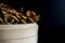 Closeup side of cinnamon cap mushroom in bamboo bowl on dark background