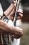 Closeup side view of mans hands playing banjo.