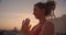 Closeup side view portrait of spiritual female with dreadlocks practicing yoga smiling happily on rooftop with beautiful