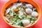 Closeup on simple Chinese fishball noodle soup served in bowl