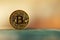 Closeup of a single bitcoin over a nice blurred background. 3D render