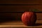 Closeup of a single Gala Apple in a wooden packing crate