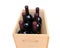 Closeup of six Cabernet Sauvignon wine bottles in a wooden crate.