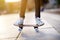 Closeup of skateboarder legs. Kid riding skateboard outdoor.