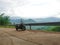 Closeup of a  sleek motorcycle parked at the on the road surrounded by majestic mountains