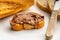 Closeup of a slice of loaf bread with chocolate paste spread on it