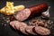 Closeup sliced cheddar summer sausage with cheese and garlic