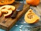 Closeup slices of chopped ripe pumpkin on a wooden cutting board