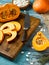 Closeup slices of chopped ripe pumpkin on a wooden cutting board