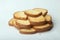 Closeup of slices of loaf bread carefully stacked like a small tower on a white surface