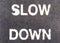 Closeup slow down marking on street, for warning the drivers to