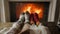 Closeup slow motion video of couple in love in warm socks lying under blanket at living room with burning fireplace