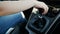 Closeup slow motion video of female driver shifting manual gears in car