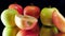 Closeup slow motion video of two halves of fresh ripe apple falling on black background. Perfect abstract shot for
