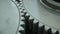 Closeup on slowly rotating iron metallic gears, 4k realistic 3d animation loop. Symbol of teamwork, industry or business.