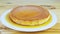 Closeup slowly zoom in on homemade whole round soft flan with caramel syrup