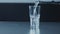 Closeup slowmotion of glass fulling with water