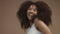 Closeup slowmotion portrait of laughin black woman with curly hair