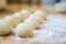 Closeup of small balls ready dough on floured kitchen table. Def