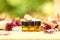 Closeup of small bottles of amber essential oil on a wooden fence under the sunlight