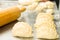 Closeup small delicious empanadas lined up before baking, rolling pin background