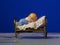 Closeup of a small figurine of a child sleeping in bed