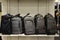 Closeup of small gray suitcases on a shelf at a store with a blurry background