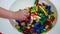 Closeup of small plastic blocks being taken by hands of kindergarten children