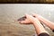 Closeup Small sturgeon in the hands of a man. Against the backdrop of the Ural River